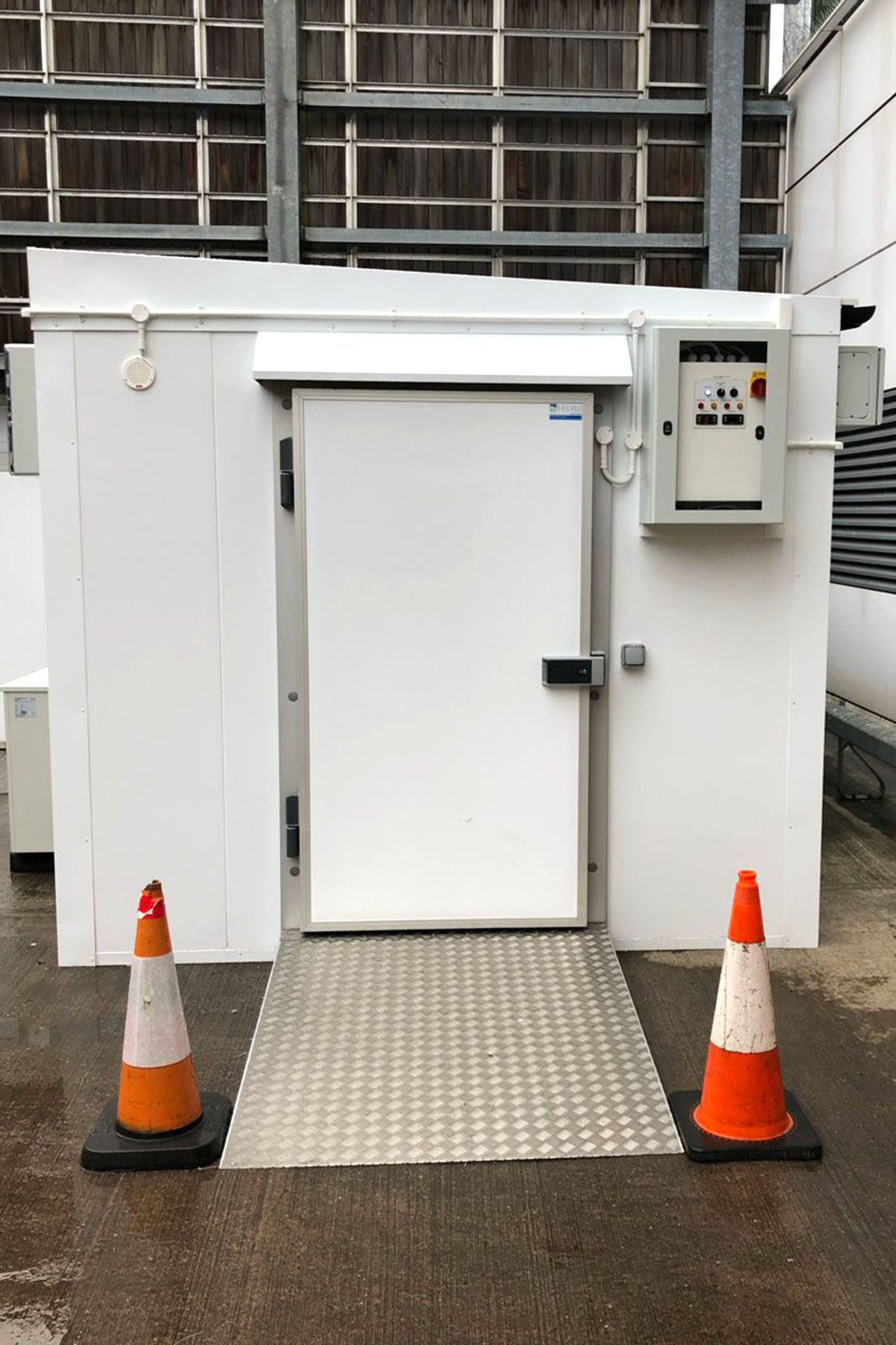 An external modular coldroom showing the coldroom door and ramp for access
