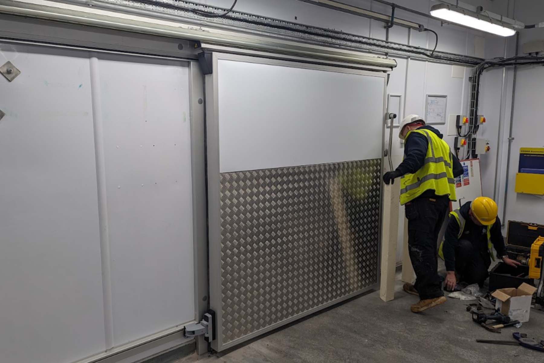 Servacool engineers fitting a new sliding coldroom door